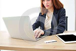 Selective focus on hands of attractive Asian business woman working with laptop in office.