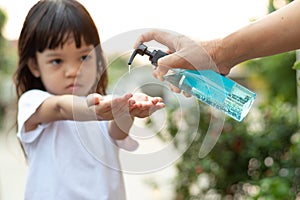 Selective focus on the hands, the girl is releasing the gel To wash her hands Frequent washing of hands with gel or alcohol Helps