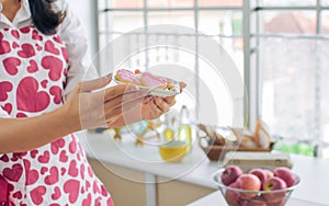 Selective focus hands holding bowl with heart cookies and biscuits to celebrate on valentine day. Blur background of woman