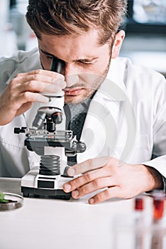 selective focus of handsome biochemist looking