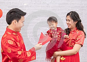 Selective focus on happy father provide envelop angpao for kid baby on Chinese New year Traditional  Chinese family spent time
