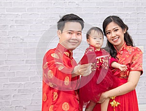 Selective focus on happy father provide envelop angpao for kid baby on Chinese New year Traditional  Chinese family spent time