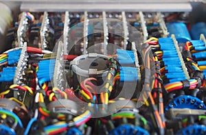 Selective focus image of complex colored wiring and connectors joining circuit boards with electrical components