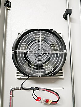 Selective focus image of exhaust fan in electrical panel.