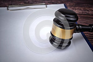 Selective focus image of gavel isolated over a wooden background. Law concept