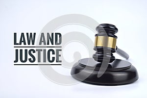 Selective focus image of gavel with law and justice wording isolated in white background. Law concept