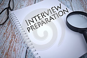 Selective focus image of magnifiying glass with spectacle and INTERVIEW PREPARATION wording. Business concept