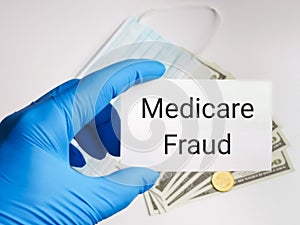 Selective focus image with noise effect hand holding white card with text Medical Fraud