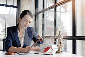 selective focus image, A professional millennial Asian female lawyer pr attorney holding a judge gavel or judge hammer