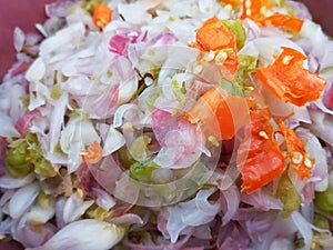 Selective Focus of Indonesian Traditional Raw Red Onion Sauce or Known As Sambal Bawang in A Container