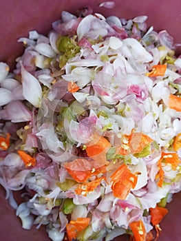 Selective Focus of Indonesian Traditional Raw Red Onion Sauce or Known As Sambal Bawang in A Container