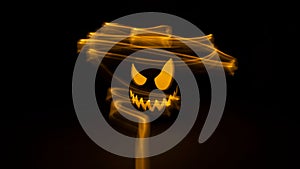 Selective focus of a jack-o-lantern pumpkin with long exposure lights for Halloween