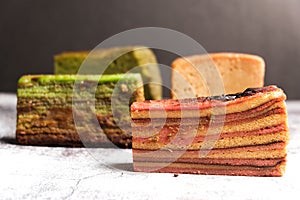 Selective focus of "kek lapis sarawak" or layer cake on stone table.