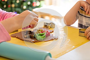 Selective focus. Kids making gingerbread cookies with various Christmas cookie cutters. Gingerbread dough. Family Christmas