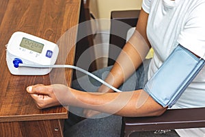 selective focus of a lady measuring blood pressure on a digital Sphygmomanometer.