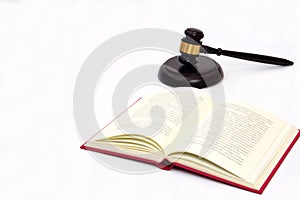 Selective focus, law book and judge gavel or hammer placed behind. Law, judiciary concept