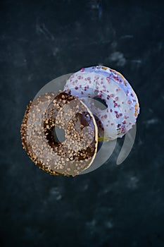 selective focus, levitating sweet doughnuts with chocolate and blueberry