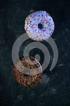 selective focus, levitating sweet doughnuts with chocolate and blueberry