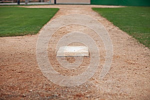 Selective focus low angle view of a baseball infield looking toward home from third base