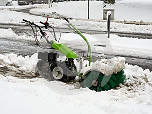 Selective focus. Machine for removing snow from pavements. Winter attack in Germany. Heavy snowfall in NRW in the Mettmann county.