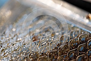 Selective focus macro of a dirty kitchen range hood filter clogged with grease.