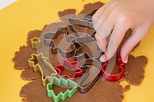 Selective focus. Making gingerbread cookies with various Christmas cookie cutters. Gingerbread dough. Family Christmas moments