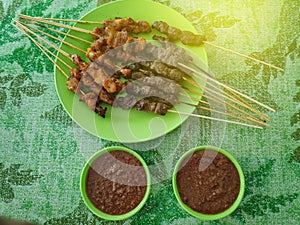 Selective focus of Malaysian beef and chicken satay with delicious peanut sauce, one of famous local dishes.