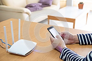 Selective focus at men hand holding smartphone device while searching for information, web browsing in front of high speed