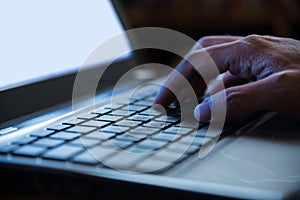 Selective focus on man hand typing laptop/PC/computer keyboard i