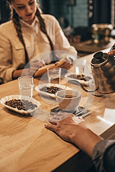 selective focus of man pouring hot water into bowl