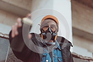 selective focus of man in respirator holding can