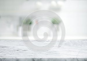 Selective focus.Marble table top on blur white kitchen room background