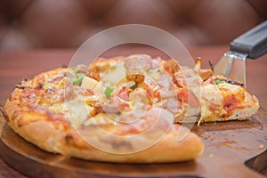 Selective Focus On Meat Deluxe Pizza Slice On Pizza Scoop