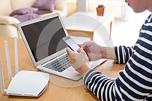 Selective focus at men hand holding smartphone device while searching for information, web browsing in front of high speed