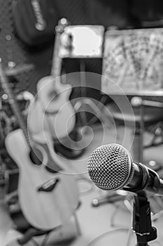 selective focus microphone and blur musical equipment guitar ,bass, drum lyric stand, background.