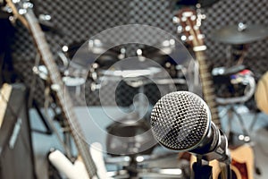 selective focus microphone and blur musical equipment guitar ,bass, drum piano background.