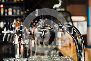 Selective focus of modern beer taps in pub