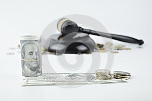 Selective focus of money , coins and judge gavel over white background