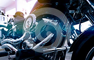 Selective focus on a motorcycle engine. Closeup motorcycle exhaust pipe, engine guard, air filter, and rear brake pedal.