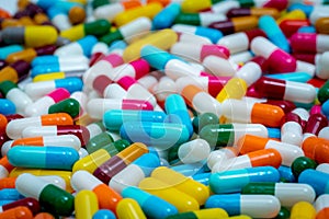 Selective focus on multi-colored antibiotic capsule pills. Antibiotic drug resistance concept. Pile of colorful capsule pills.