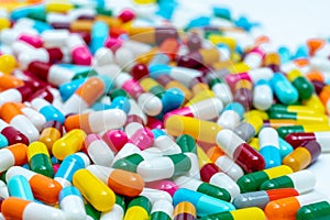 Selective focus on multi-colored antibiotic capsule pills. Antibiotic drug resistance concept. Pile of colorful capsule pills.