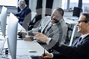 selective focus of multicultural businessmen having conversation at workplace