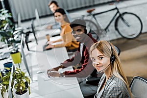 Selective focus of multiethnic smiling call center operators working
