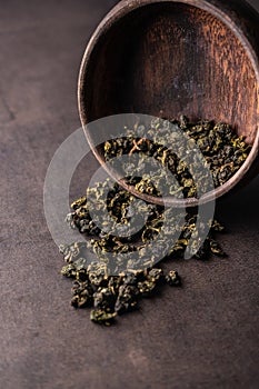 selective focus, natural green leaf tea in a wood bowl