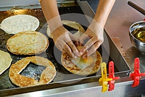Breaking egg for roti sarang burung photo