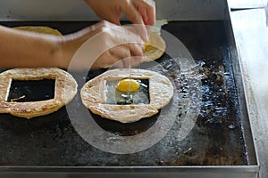 Breaking egg for roti sarang burung photo