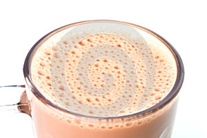 Selective focus with noise effect of milk tea or popularly known as Teh Tarik in Malaysia over white background