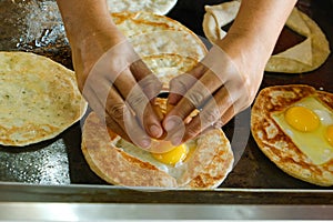 Breaking egg for roti sarang burung photo