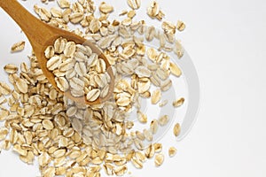 Selective focus of oat flakes in spoon on white background