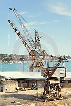 Selective focus of old crane at loading dockyard. Historical structure of old crane with rustic at port.